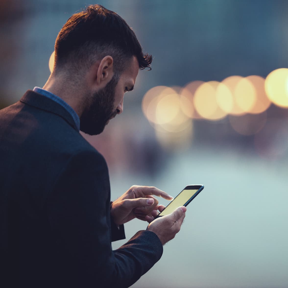 A trader using Smartphone to contact us